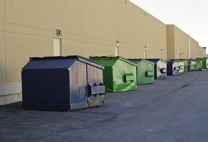 dumpsters lined up for use on busy construction site in Brookline